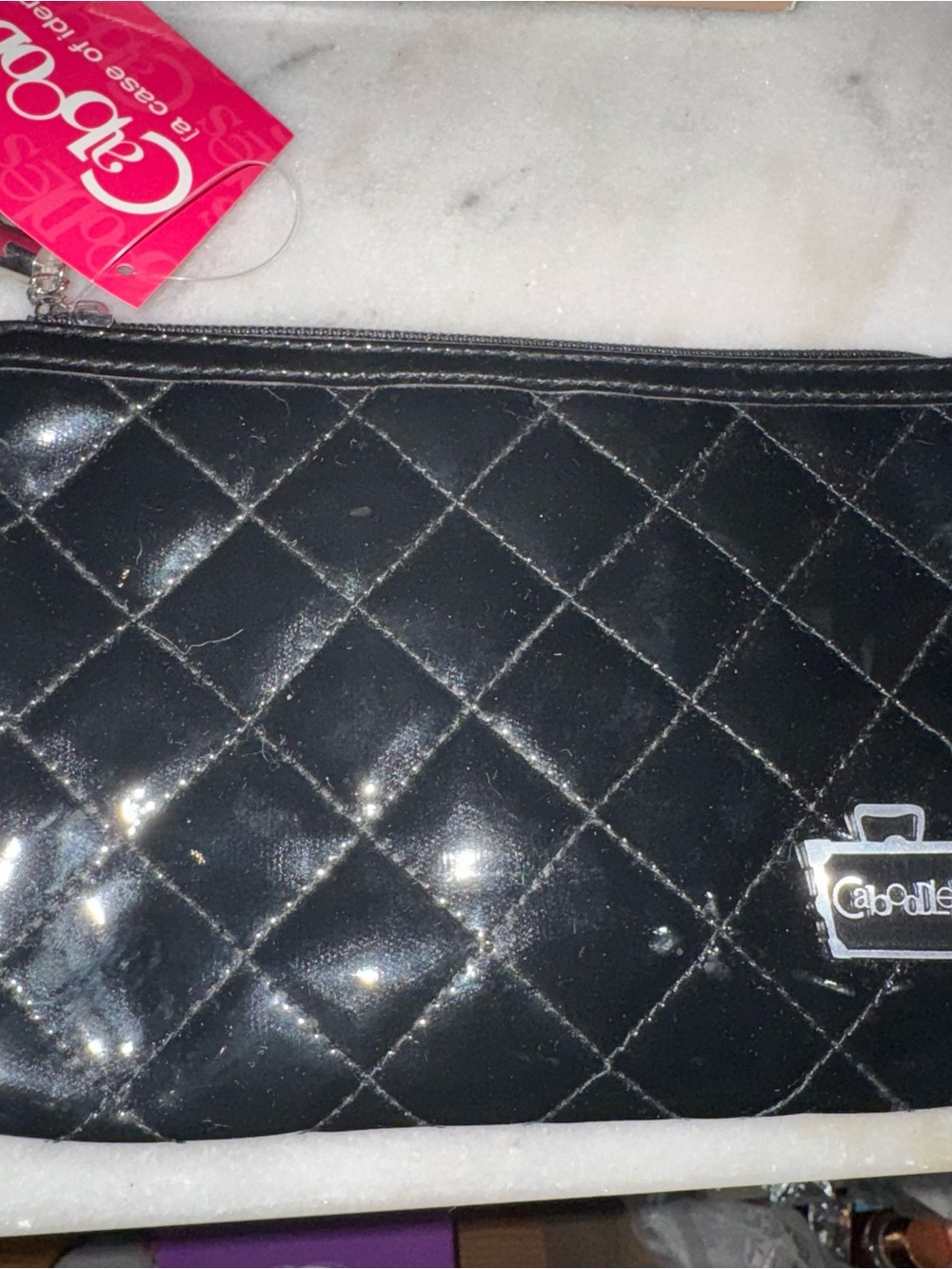 Shiny black quilted cosmetics bag